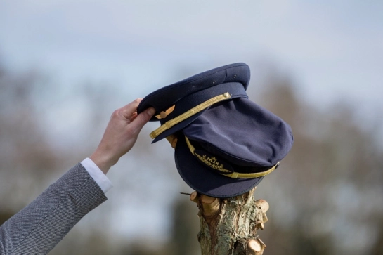 A pilot’s cap hung on a post