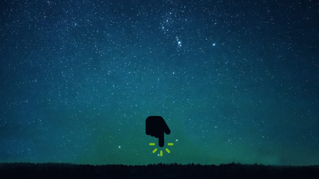 A shadow of a hand pointing downward under a starry sky
