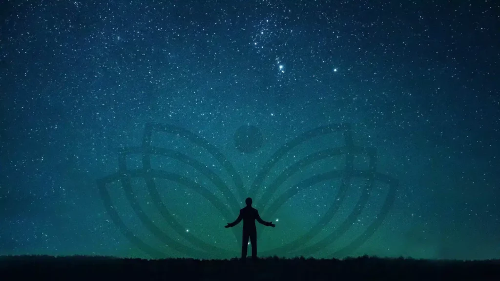 Silhouette with open arms under a starry sky