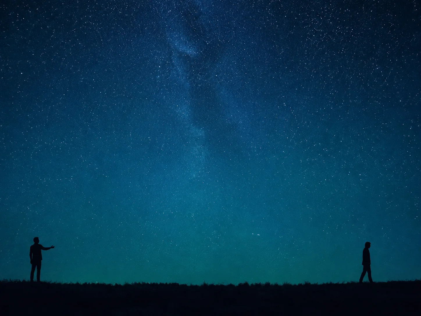 One silhouette reaching toward another who is walking away beneath a star-filled sky