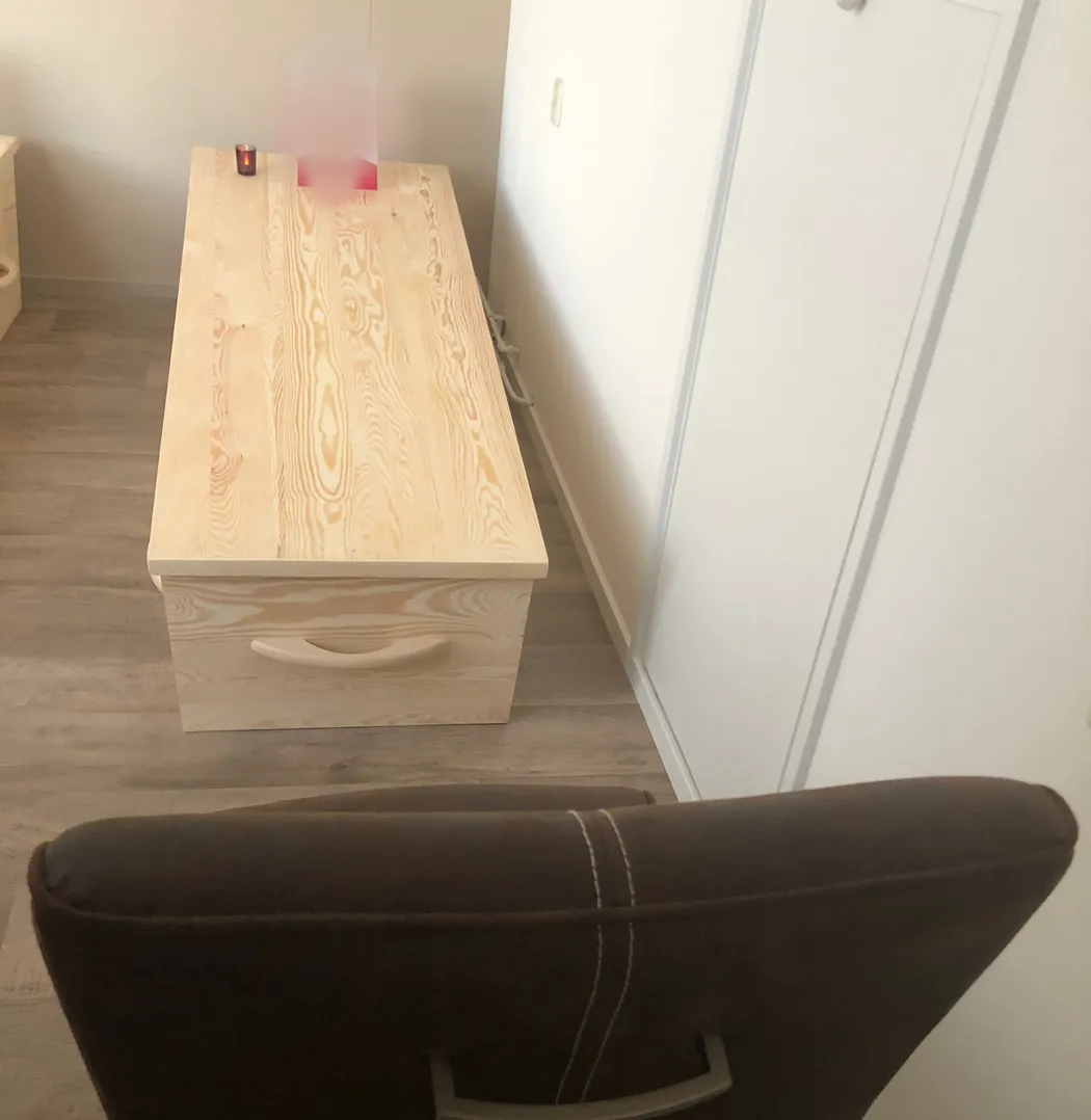 One closed pine coffin at a memento mori seminar in the Netherlands in May 2018, with a candle and a participant's photo on the lid